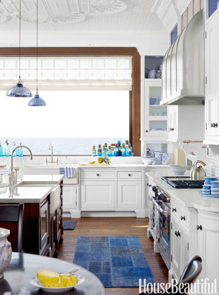 This kitchen uses a clean, coastal decor that overlooks the lake. Coastal Decor in a Kitchen
